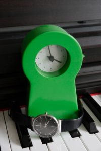 A clock, a watch and a piano